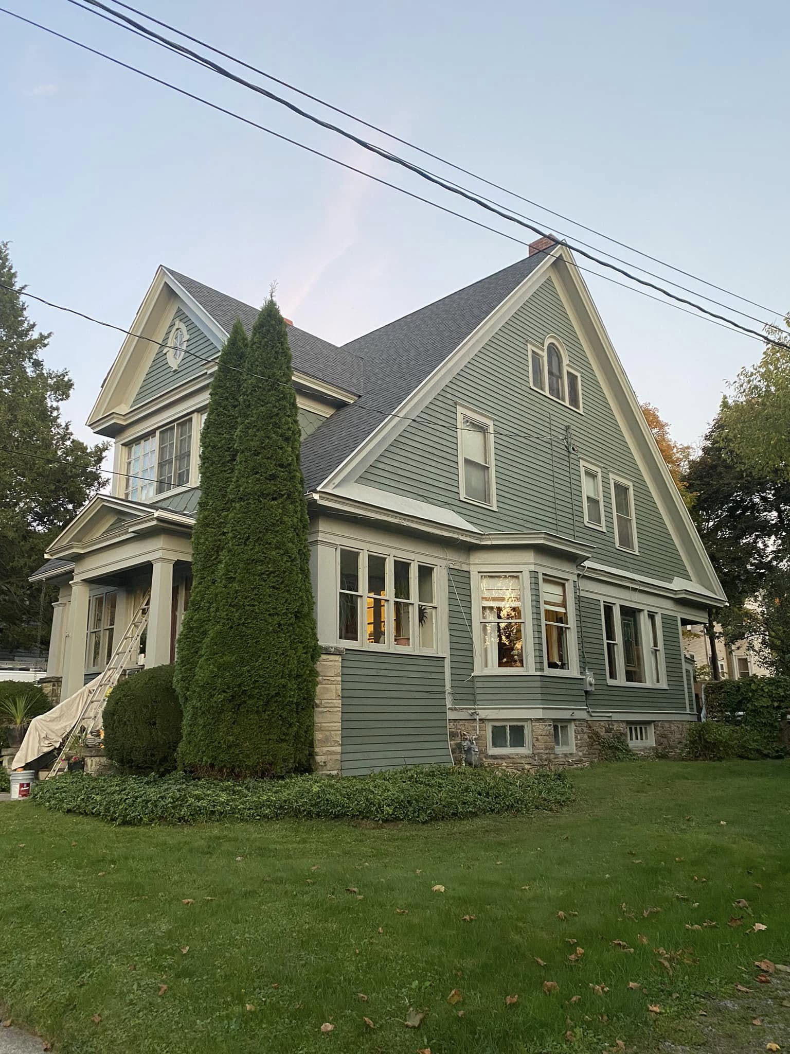 Two-story home with fresh sage green exterior paint and cream trim