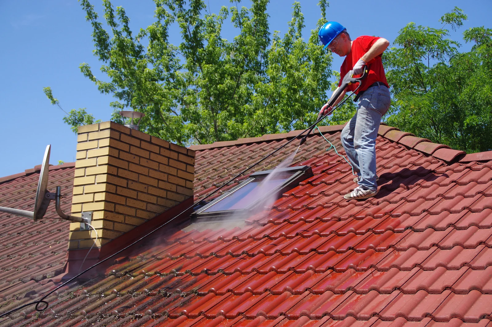 Soft washing a mossy tile roof